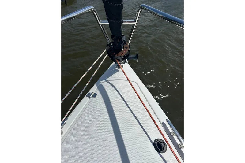 Slide: The Image of Bow of 2023 Corsair 880 sailboat with rigging over water. - 7
