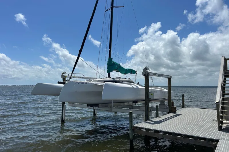 Slide: The Image of 2023 Corsair 880 sailboat docked on a sunny day with blue skies. - 8