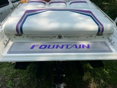 Slide: The Image of Rear view of a 1998 Fountain 27 Fever boat with purple accents. - 11