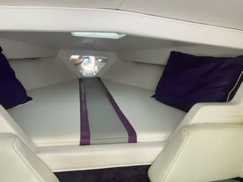 Slide: The Image of Interior of a 1998 Fountain 27 Fever boat with purple cushions. - 4