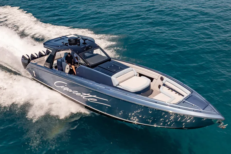 Slide: The Image of 2024 Cigarette 42' Auroris speedboat cruising on clear blue water. - 10