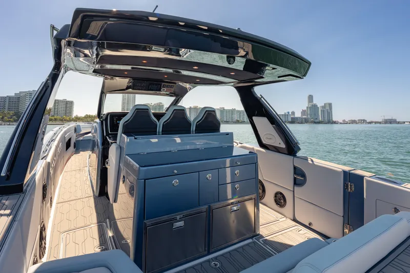 Slide: The Image of 2024 Cigarette 42' Auroris luxury boat interior with sleek design and city skyline view. - 20