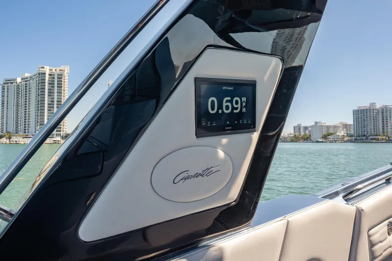 Slide: The Image of 2024 Cigarette 42' Auroris dashboard with GPS speed display on a sunny day. - 28