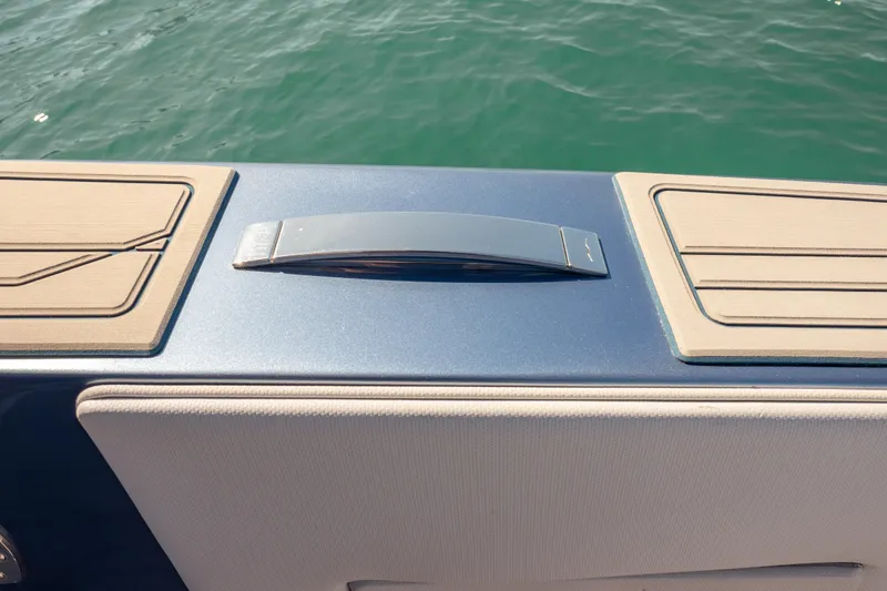 Slide: The Image of 2024 Cigarette 42' Auroris boat deck detail with sleek design and water backdrop. - 31
