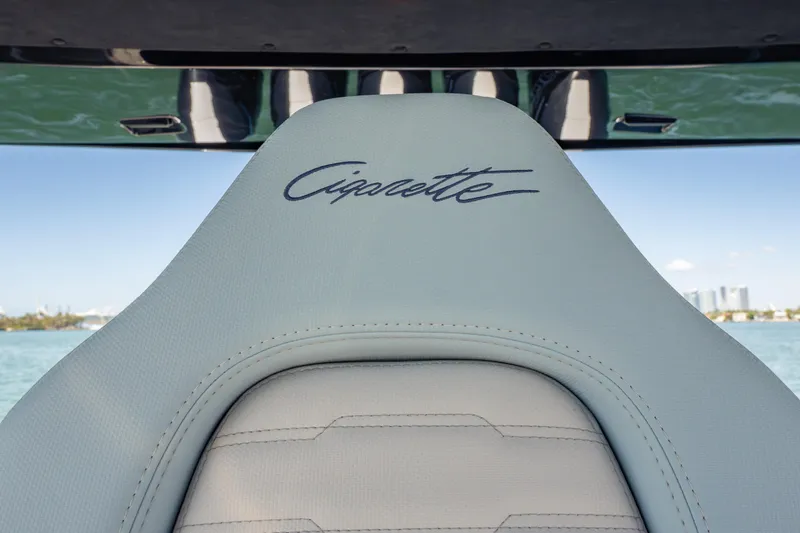 Slide: The Image of 2024 Cigarette 42' Auroris boat seat with logo, ocean view in background. - 35
