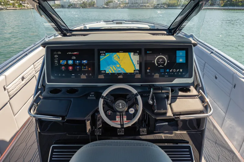 Slide: The Image of 2024 Cigarette 42' Auroris boat dashboard with advanced navigation displays and controls. - 38