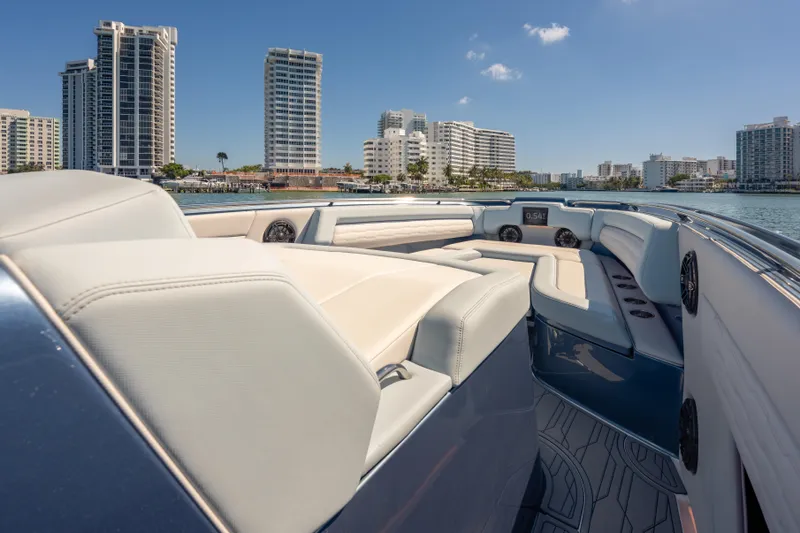 Slide: The Image of 2024 Cigarette 42' Auroris luxury boat interior with city skyline backdrop. - 39