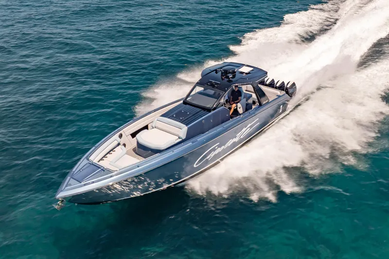 Slide: The Image of 2024 Cigarette 42' Auroris speedboat cruising on clear blue ocean waters. - 4