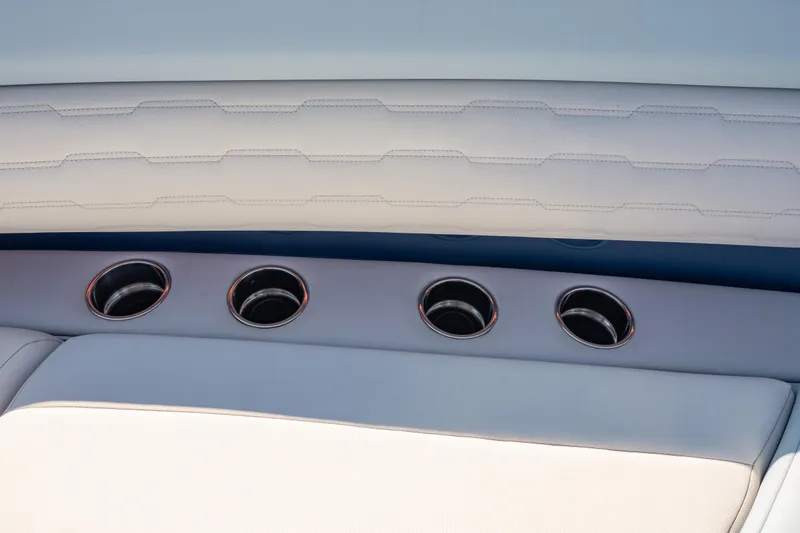 Slide: The Image of Interior detail of 2024 Cigarette 42' Auroris boat, featuring sleek cup holders and luxurious seating. - 41