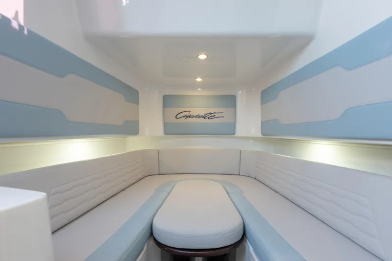 Slide: The Image of 2024 Cigarette 42' Auroris interior with sleek white and blue seating, modern design. - 47