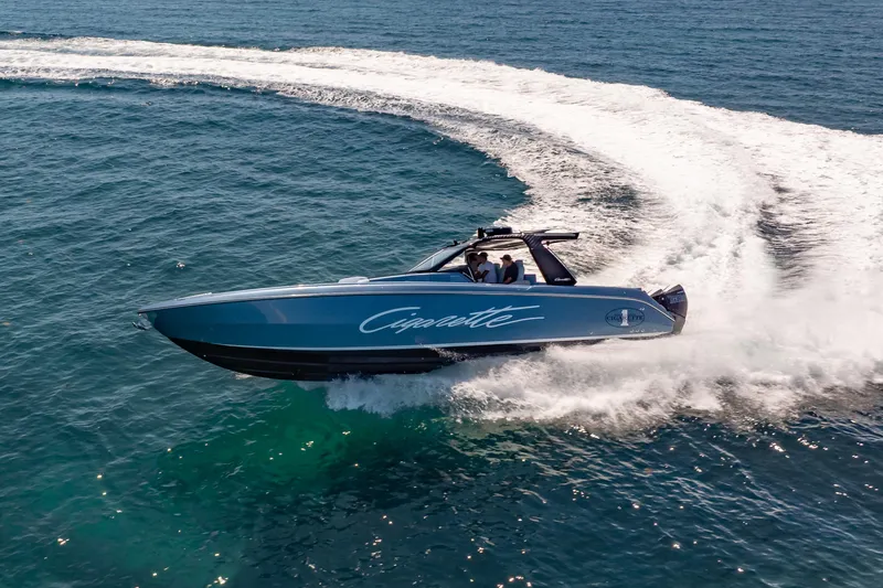 Slide: The Image of 2024 Cigarette 42' Auroris speedboat making a sharp turn on open water. - 5