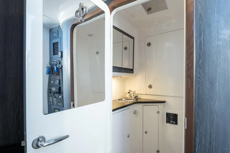 Slide: The Image of 2024 Cigarette 42' Auroris yacht interior with sleek cabinetry and modern fixtures. - 53