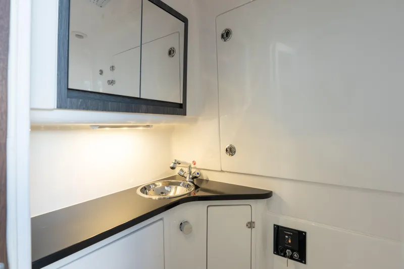 Slide: The Image of 2024 Cigarette 42' Auroris boat interior with sleek sink and storage cabinets. - 54
