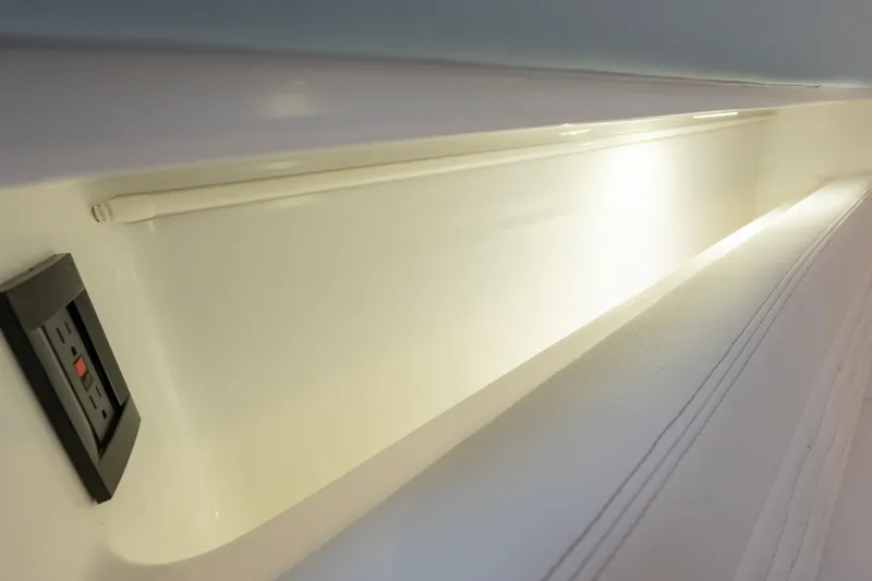 Slide: The Image of 2024 Cigarette 42' Auroris interior detail with lighting and power outlet. - 55