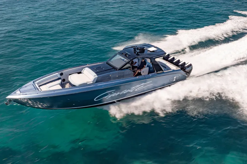 Slide: The Image of 2024 Cigarette 42' Auroris speedboat cruising on clear blue ocean waters. - 8