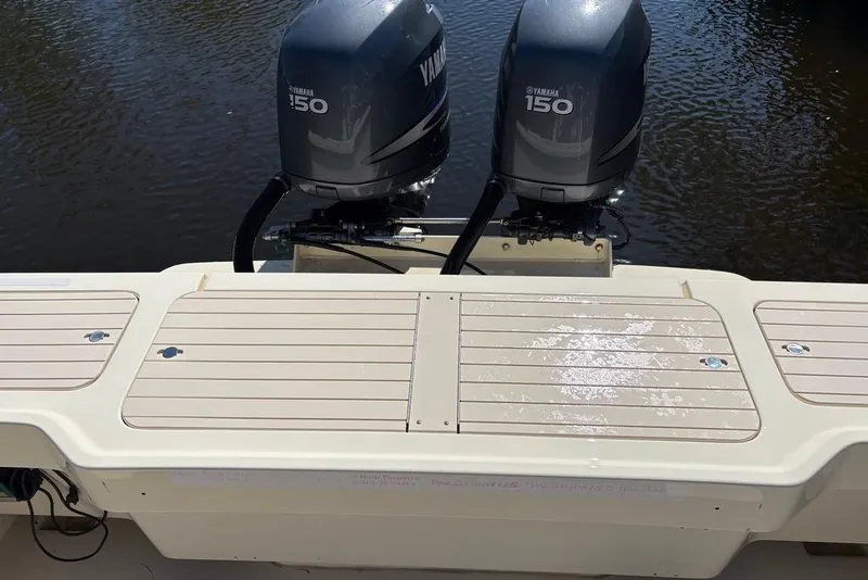 Slide: The Image of 2008 Parker 2510 XL Walkaround boat with twin Yamaha 150 engines on water. - 10