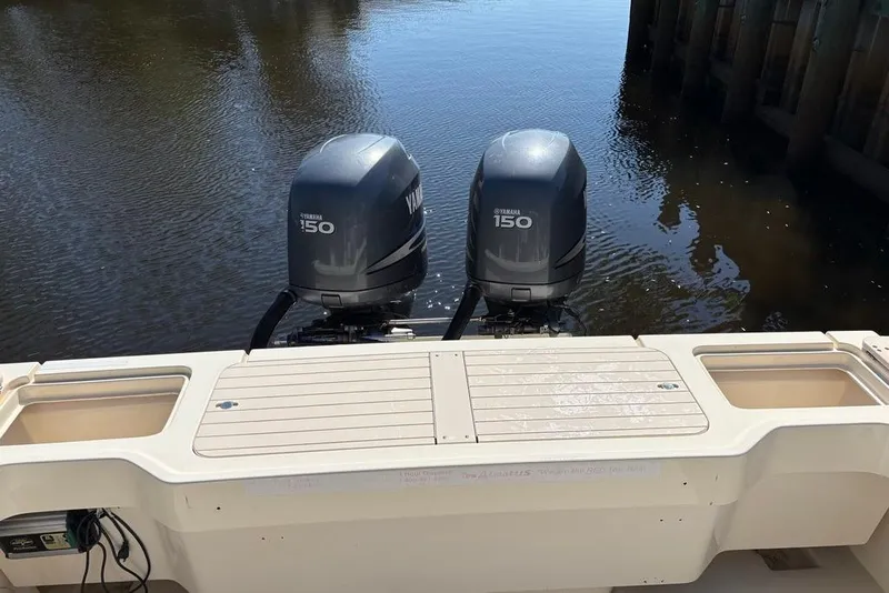 Slide: The Image of 2008 Parker 2510 XL Walkaround boat with twin Yamaha 150 engines on calm water. - 12