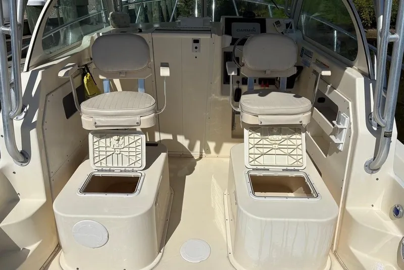 Slide: The Image of 2008 Parker 2510 XL Walkaround boat interior with dual seats and storage compartments. - 13