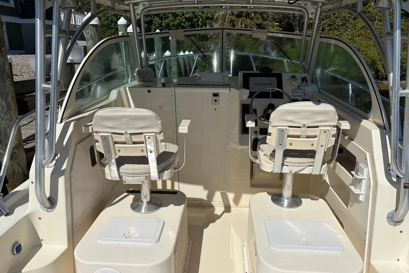 Slide: The Image of 2008 Parker 2510 XL Walkaround boat interior with dual seats and steering console. - 14