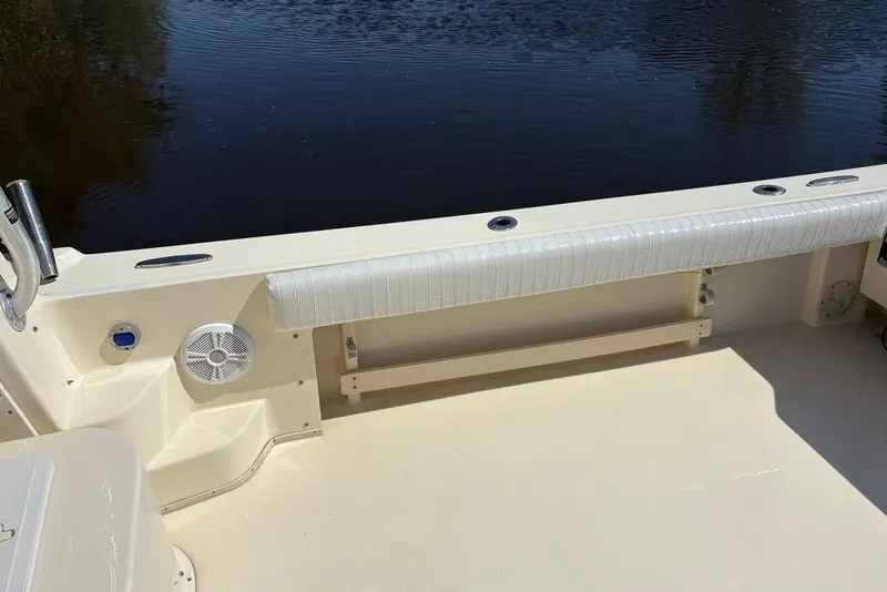 Slide: The Image of 2008 Parker 2510 XL Walkaround boat interior with cushioned seating and water view. - 16