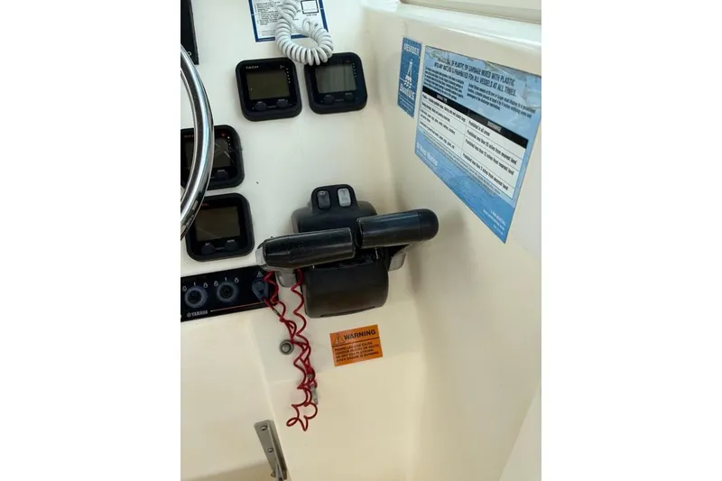 Slide: The Image of Control panel of a 2008 Parker 2510 XL Walkaround boat with gauges and throttle. - 20