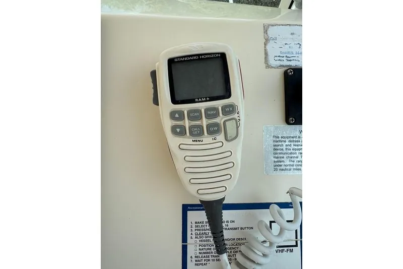 Slide: The Image of VHF radio on 2008 Parker 2510 XL Walkaround boat dashboard. - 22