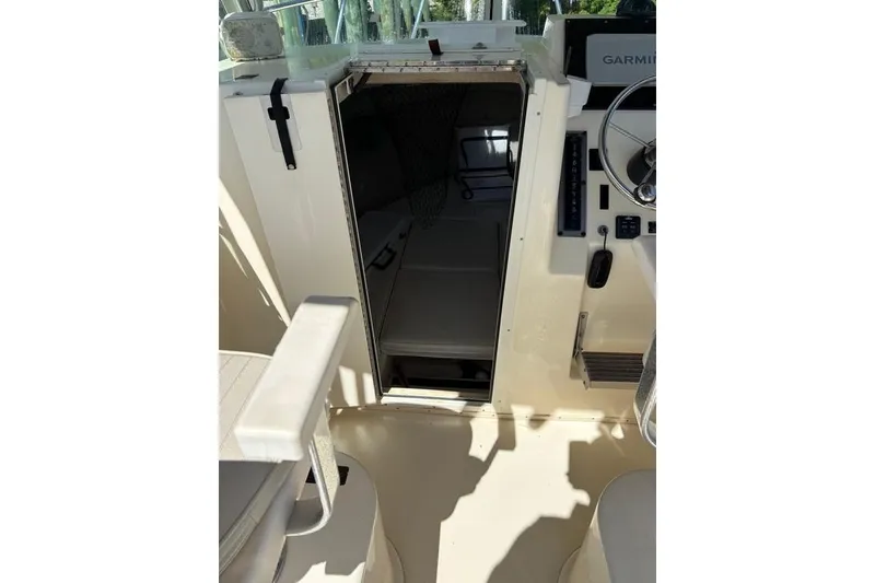 Slide: The Image of 2008 Parker 2510 XL Walkaround cabin entrance with helm and seating area. - 25