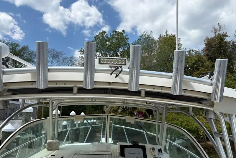 Slide: The Image of 2008 Parker 2510 XL Walkaround boat with rod holders and Garmin navigation system. - 29