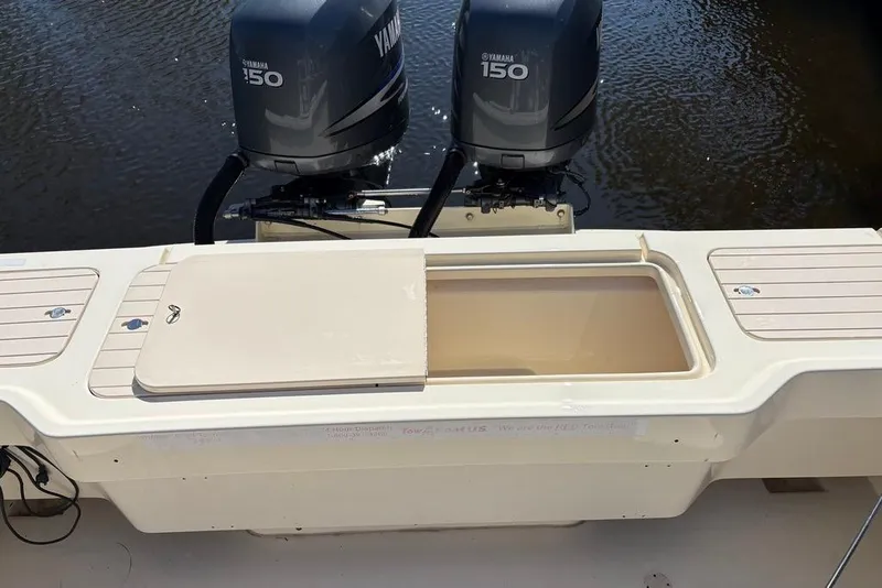 Slide: The Image of 2008 Parker 2510 XL Walkaround boat with Yamaha 150 engines, open storage compartment. - 8
