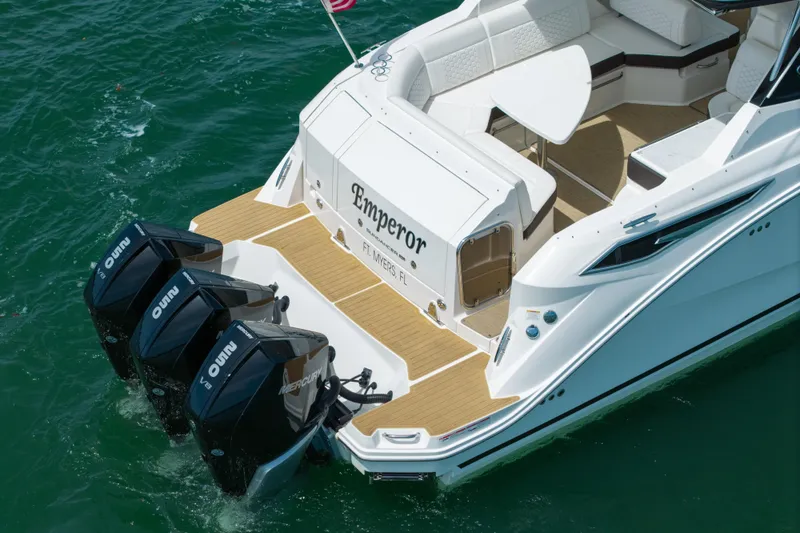 Slide: The Image of 2024 Sea Ray Sundancer 320 Outboard with triple Mercury engines on turquoise water. - 14