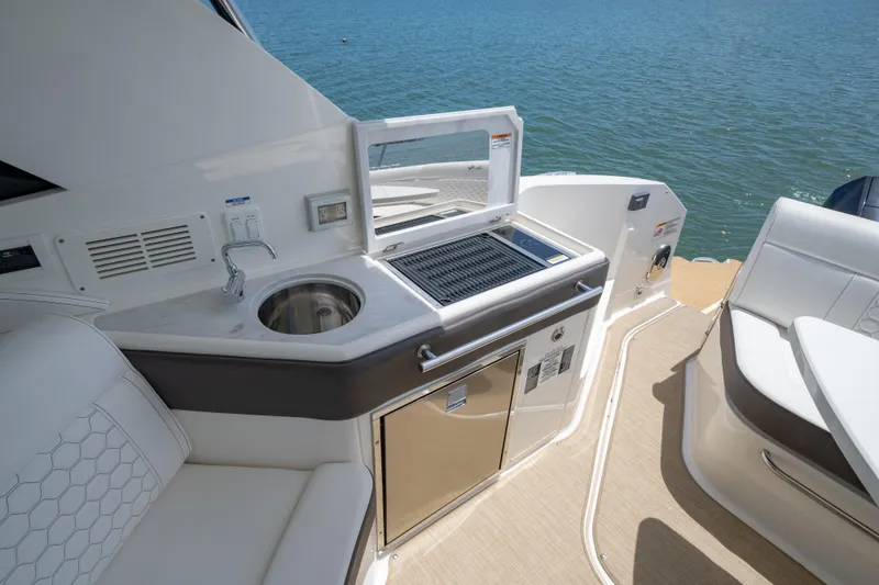 Slide: The Image of Luxurious 2024 Sea Ray Sundancer 320 Outboard yacht with sleek outdoor kitchenette. - 18