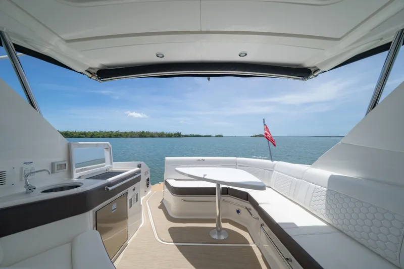 Slide: The Image of Luxurious 2024 Sea Ray Sundancer 320 Outboard yacht interior with ocean view and seating area. - 22