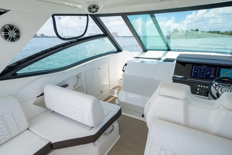 Slide: The Image of 2024 Sea Ray Sundancer 320 Outboard cockpit with modern dashboard and luxurious seating. - 24