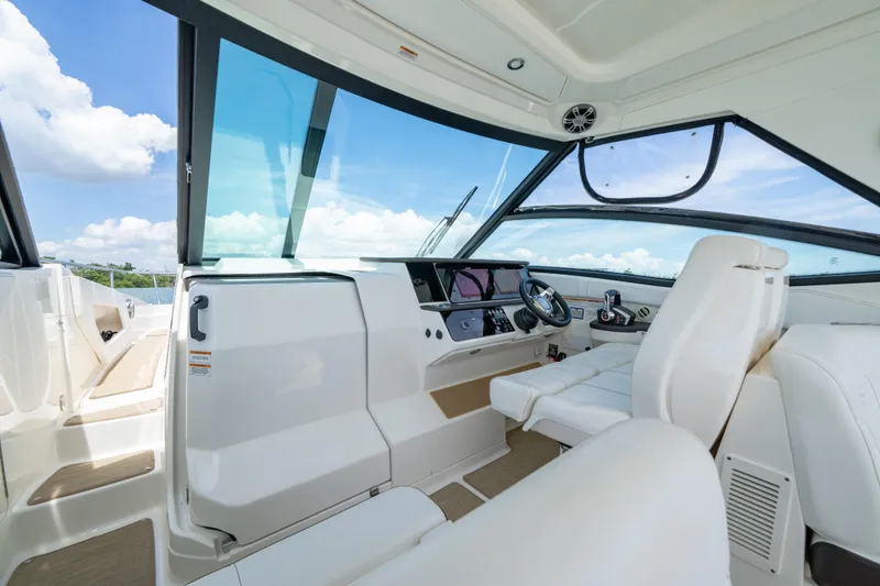 Slide: The Image of 2024 Sea Ray Sundancer 320 Outboard cockpit with modern controls and seating. - 25
