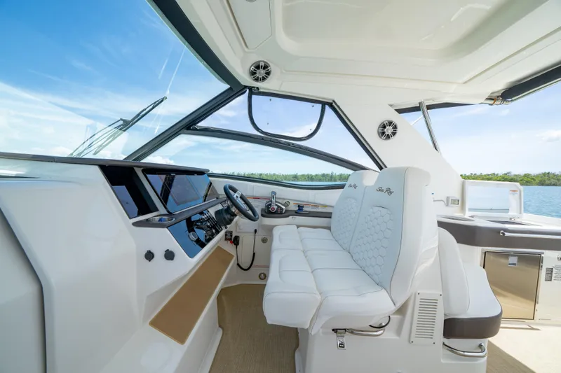Slide: The Image of 2024 Sea Ray Sundancer 320 Outboard helm with luxurious seating and modern controls. - 26