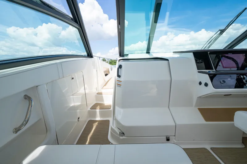 Slide: The Image of 2024 Sea Ray Sundancer 320 Outboard cockpit with modern controls and panoramic windows. - 28