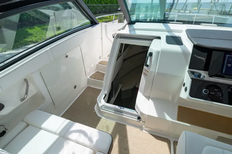 Slide: The Image of 2024 Sea Ray Sundancer 320 Outboard interior with cabin entrance and seating area. - 29