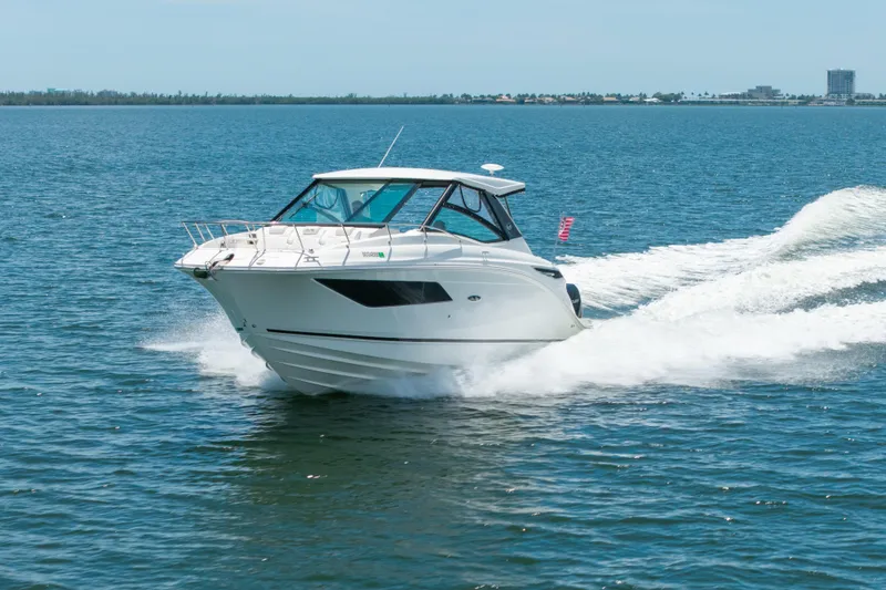 Slide: The Image of 2024 Sea Ray Sundancer 320 Outboard cruising on open water. - 3