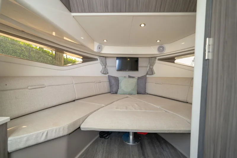 Slide: The Image of 2024 Sea Ray Sundancer 320 Outboard cabin interior with cozy seating and modern decor. - 31
