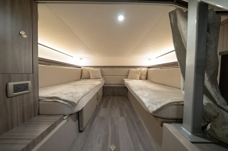 Slide: The Image of 2024 Sea Ray Sundancer 320 Outboard cabin interior with twin beds and modern design. - 33