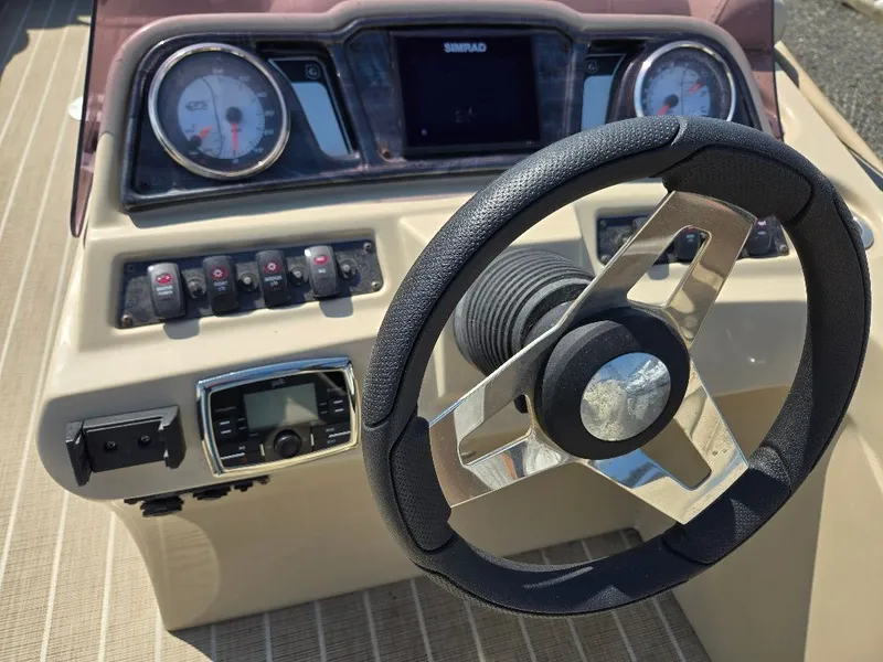 Slide: The Image of Steering console of a 2019 Godfrey Sweetwater 2386 Coastal Tritoon. - 11