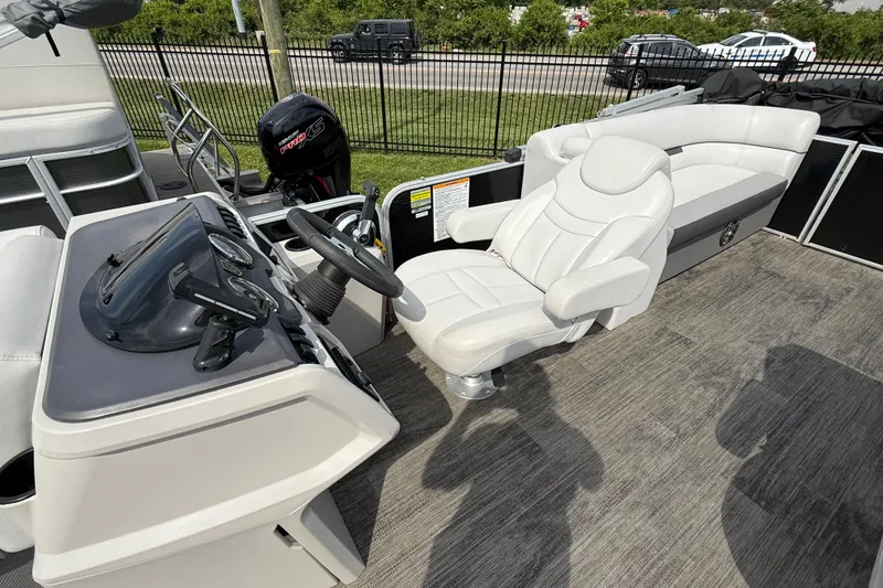 Slide: The Image of 2023 Godfrey Sweetwater 2286 SB boat interior with helm, steering wheel, and seating. - 5
