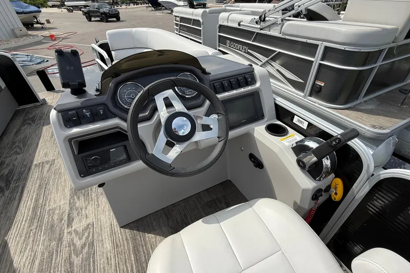 Slide: The Image of 2023 Godfrey Sweetwater 2286 SB boat dashboard with steering wheel and controls. - 6