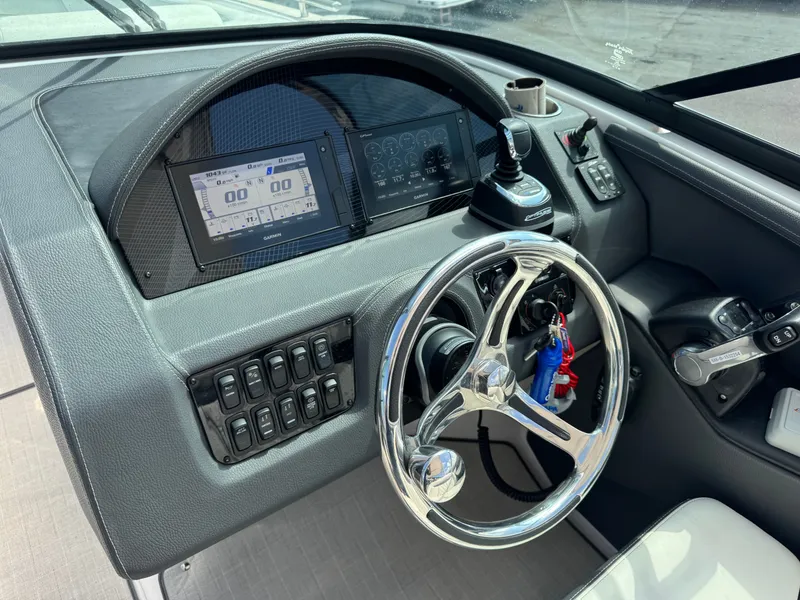 Slide: The Image of 2021 Regal 29 OBX cockpit with steering wheel and controls. - 15