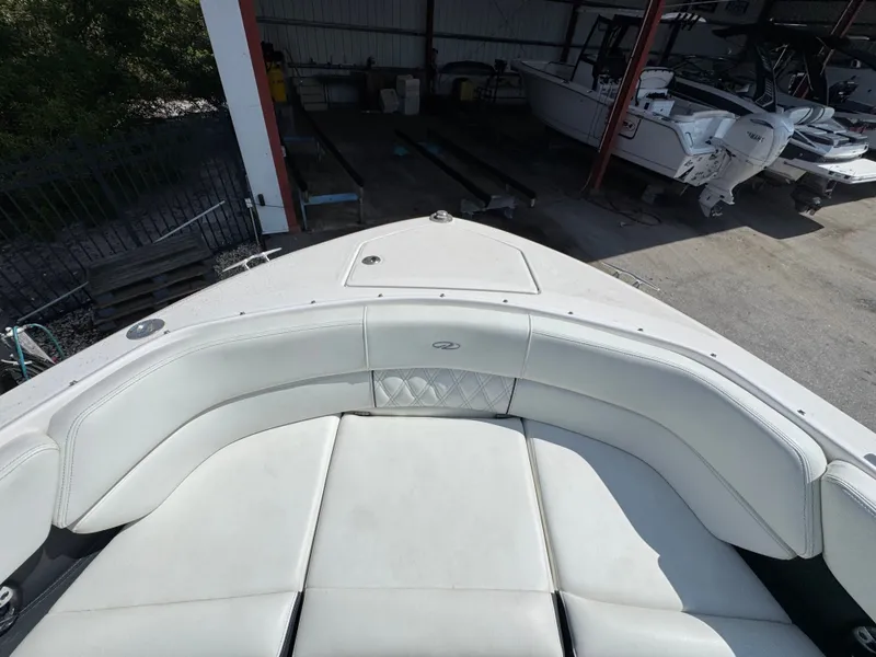 Slide: The Image of Regal 29 OBX 2021 boat with white cushioned seating in dock. - 18