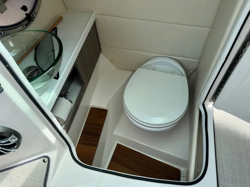 Slide: The Image of Interior of 2021 Regal 29 OBX with toilet and sink. - 21
