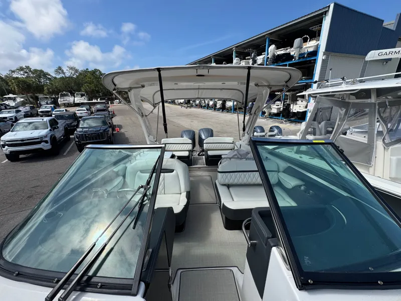 Slide: The Image of Regal 29 OBX 2021 boat docked with open canopy. - 24