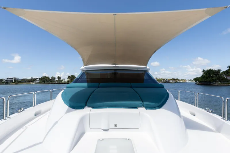 Slide: The Image of 2014 Hatteras 80 Motor Yacht Sky Lounge with sunshade on deck, cruising on a sunny day. - 14