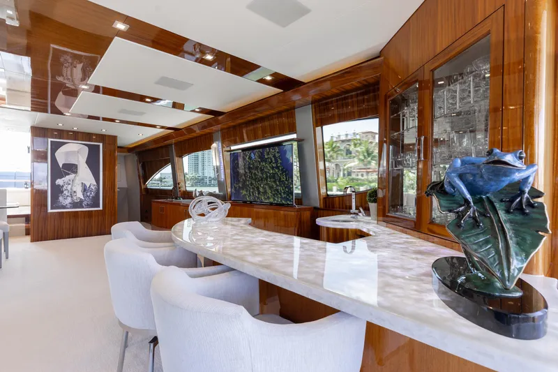 Slide: The Image of Luxurious interior of 2014 Hatteras 80 Motor Yacht Sky Lounge with elegant decor and seating. - 16