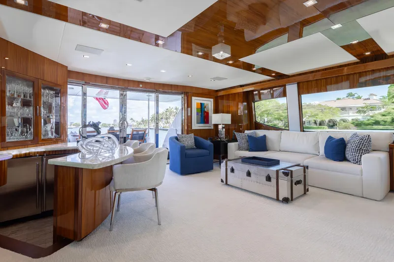 Slide: The Image of Luxurious interior of 2014 Hatteras 80 Motor Yacht Sky Lounge with elegant furnishings and large windows. - 21